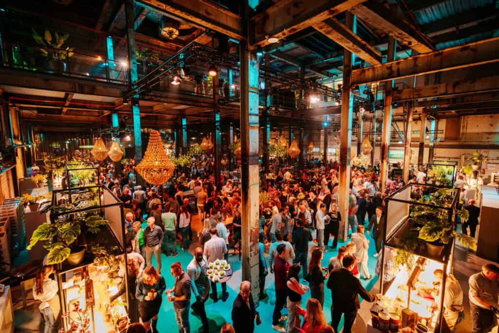 Evenementlocatie met grote menigte tijdens relatie event in industriële setting.
